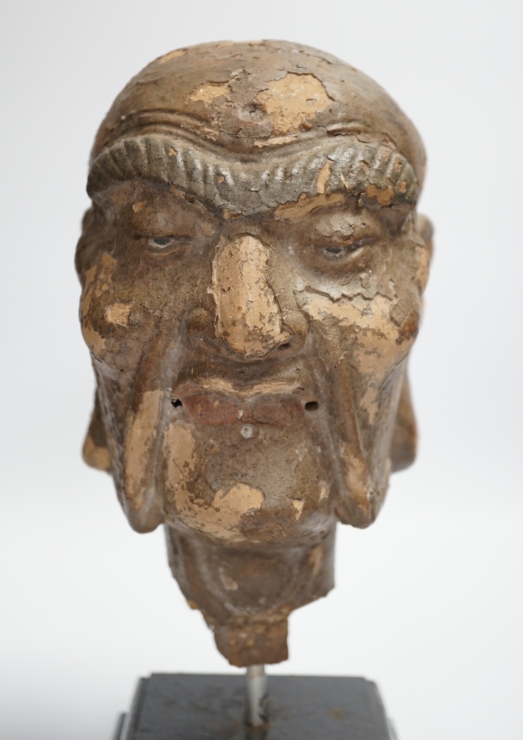 A Chinese lacquered clay head of a luohan, probably Ming dynasty, on stand, head 22cm high